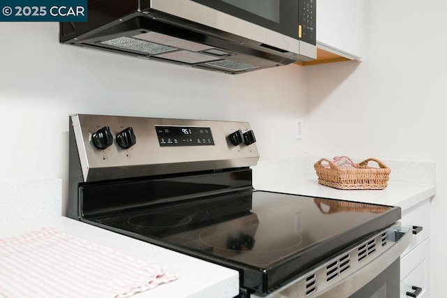 kitchen with white cabinets and appliances with stainless steel finishes