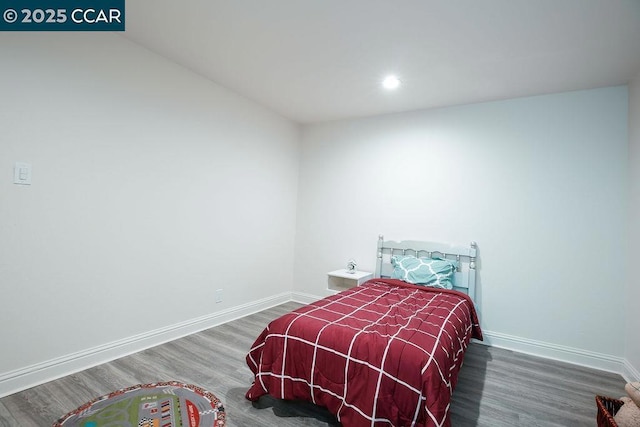 bedroom with dark hardwood / wood-style flooring