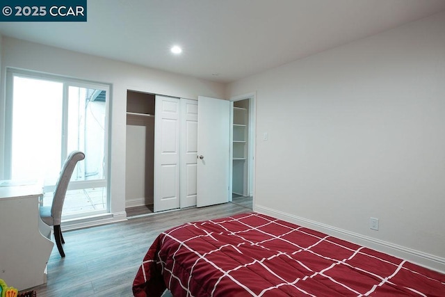 bedroom featuring hardwood / wood-style floors and a closet