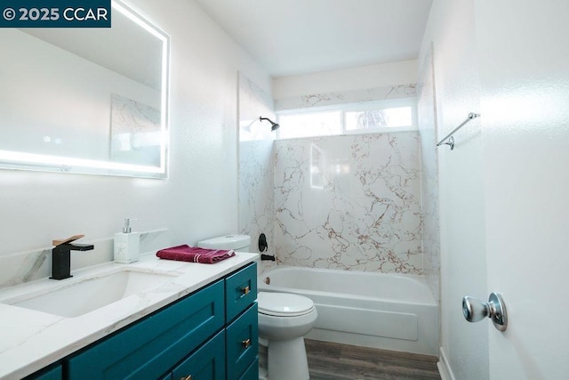 full bathroom with vanity, toilet, wood-type flooring, and tiled shower / bath combo