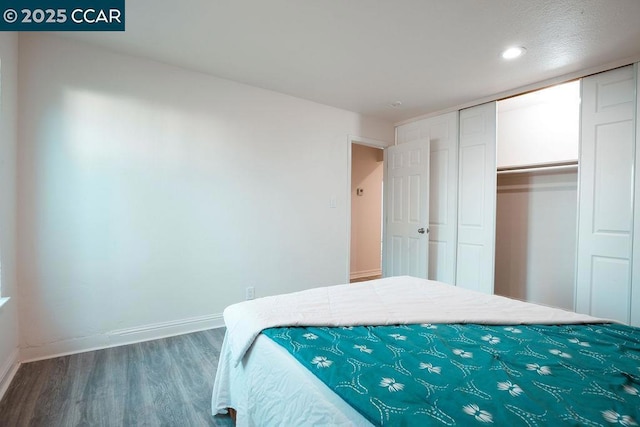 bedroom featuring wood-type flooring and a closet