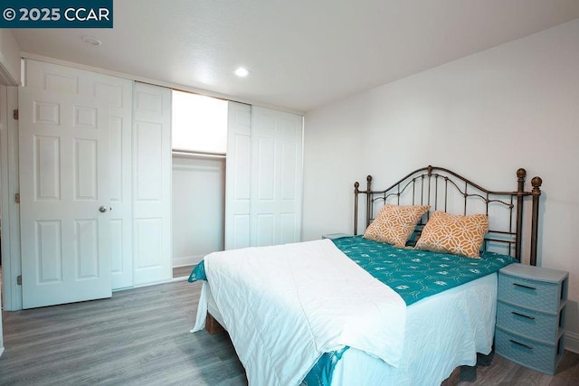 bedroom with hardwood / wood-style flooring and a closet