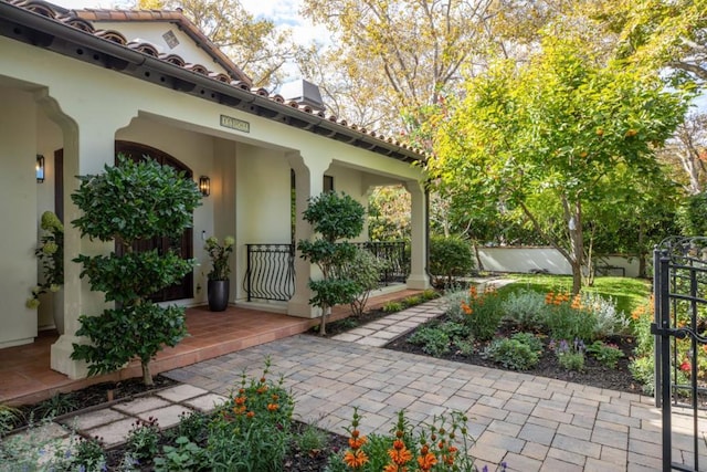 view of exterior entry featuring covered porch