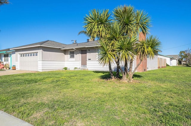 view of front facade with a garage and a front lawn