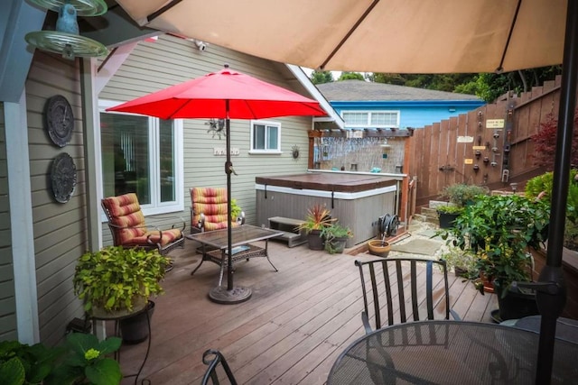 wooden terrace featuring a hot tub