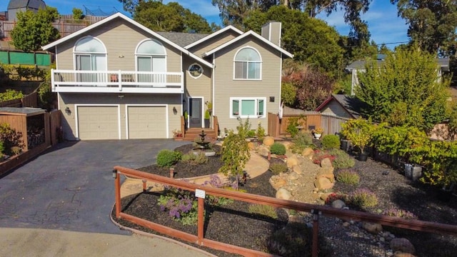 front of property with a garage and a balcony