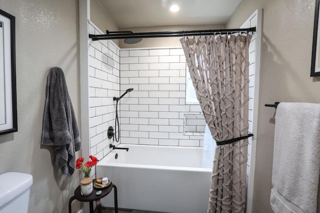 bathroom with shower / bath combination with curtain and toilet