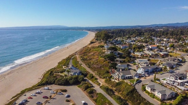 birds eye view of property with a beach view and a water view