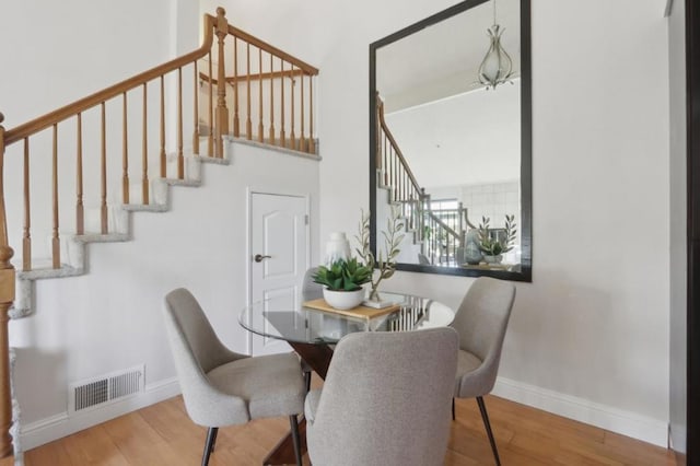 dining space with hardwood / wood-style flooring