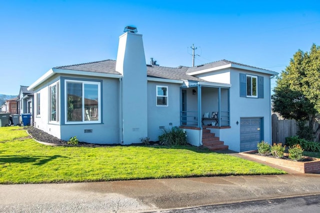 view of front of house featuring a front yard and a garage