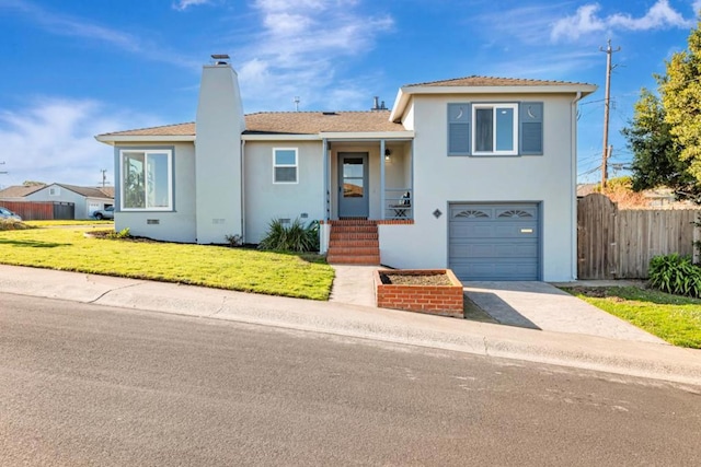 view of front of property with a front lawn and a garage