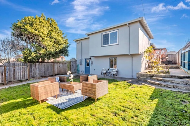 rear view of property with a yard and an outdoor hangout area