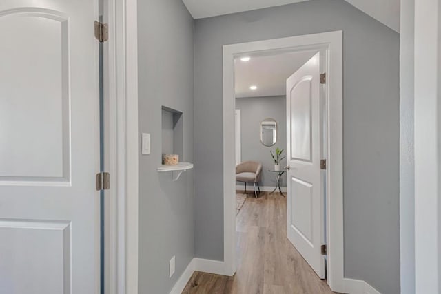 hallway with light hardwood / wood-style floors