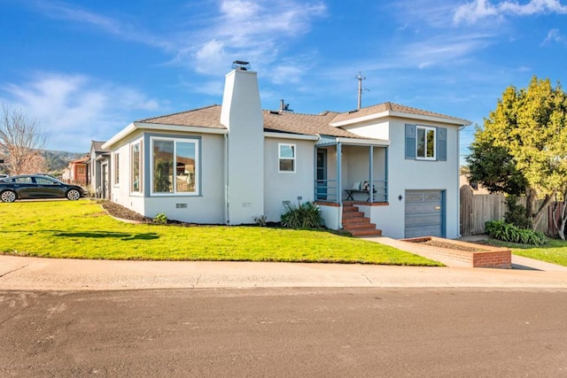 view of front of property with a front yard and a garage