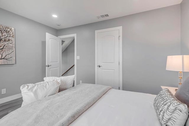 bedroom with dark hardwood / wood-style floors