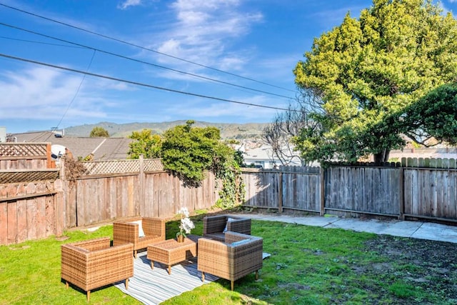 view of yard featuring an outdoor living space and a mountain view