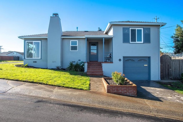 split level home with a front lawn and a garage