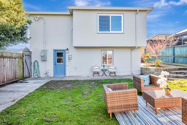 back of property featuring a lawn, outdoor lounge area, and a patio