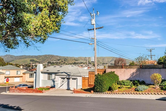 view of front of house featuring a garage and a mountain view