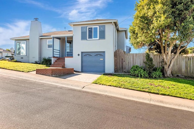 view of front of house with a garage and a front yard