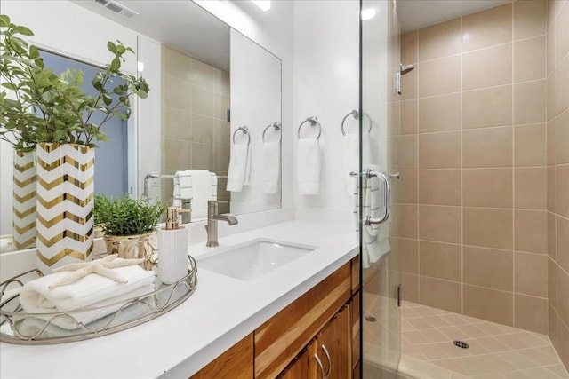 bathroom featuring vanity and a shower with door