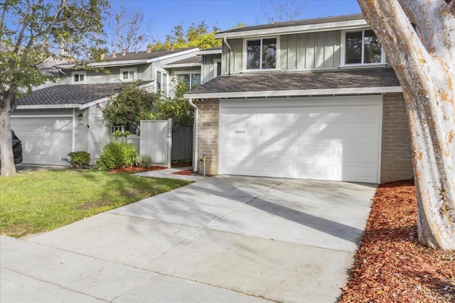 view of front of home with a garage and a front lawn