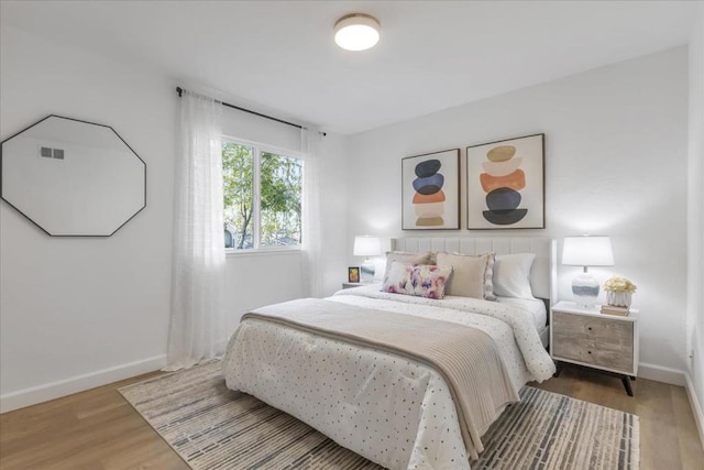 bedroom with hardwood / wood-style floors