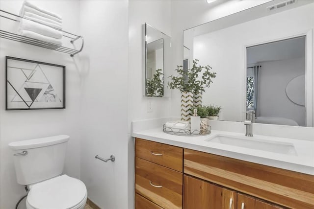 bathroom with toilet and vanity