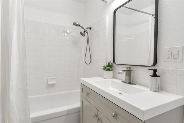 bathroom featuring decorative backsplash, vanity, and shower / bath combo