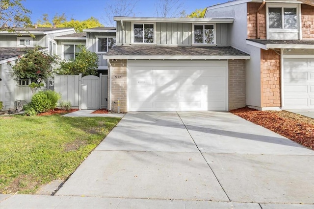 view of front facade featuring a garage and a front lawn