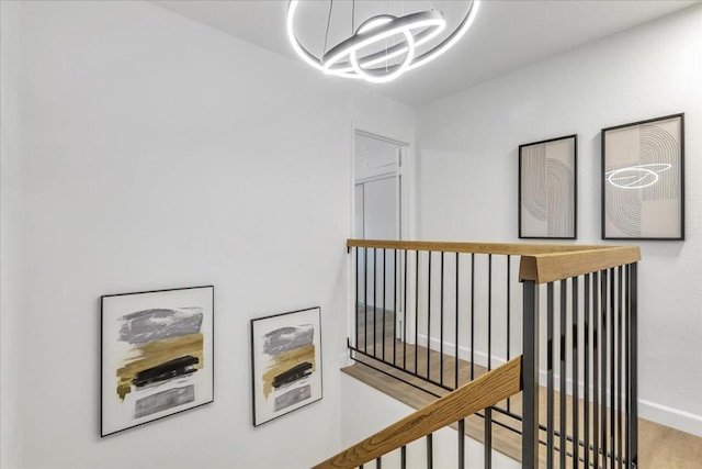 corridor featuring light hardwood / wood-style flooring and a chandelier