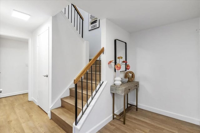 stairway with hardwood / wood-style floors