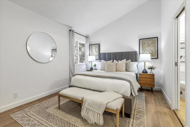 bedroom featuring vaulted ceiling and light hardwood / wood-style floors