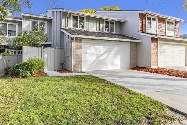 view of front of house with a garage and a front lawn