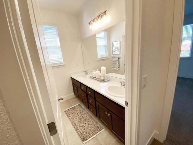 bathroom with tile patterned flooring, vanity, and plenty of natural light