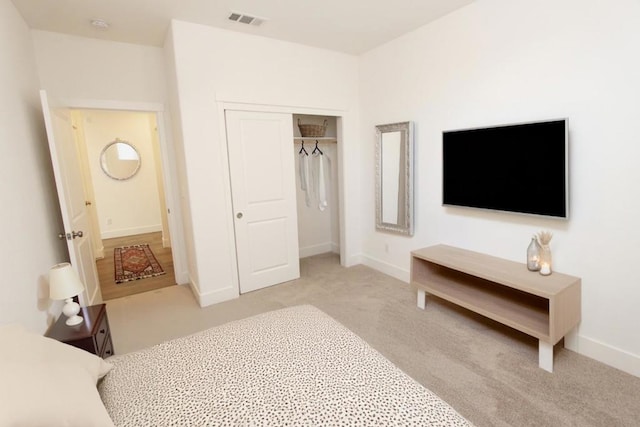 carpeted bedroom with a closet