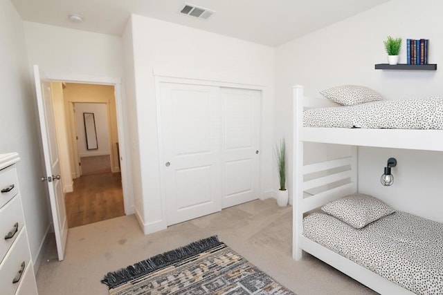 carpeted bedroom with a closet