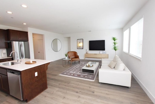 living room featuring light hardwood / wood-style floors and sink