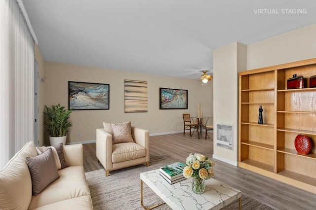 living room with ceiling fan and wood-type flooring