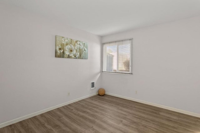 spare room with hardwood / wood-style flooring