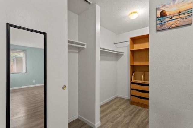 spacious closet featuring hardwood / wood-style floors