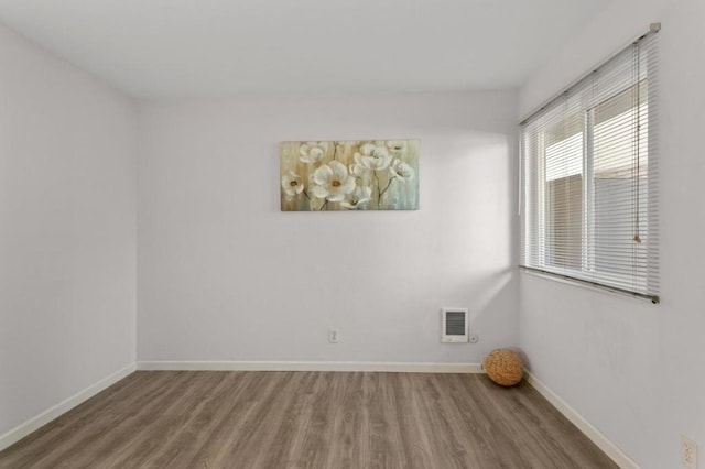 unfurnished room featuring hardwood / wood-style flooring