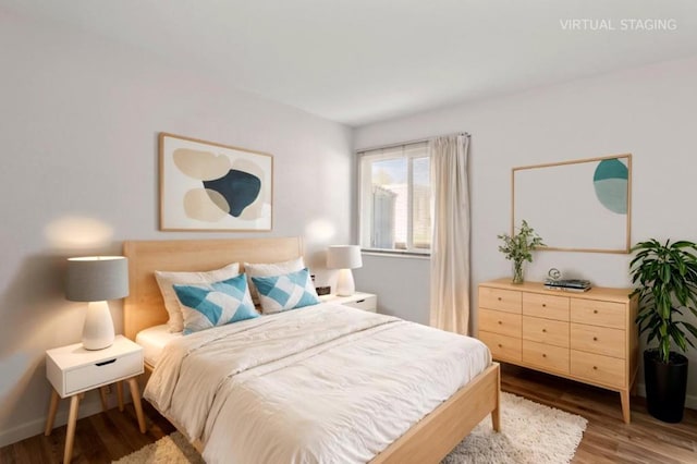 bedroom with dark hardwood / wood-style flooring