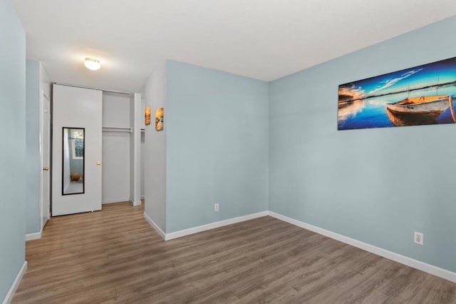 empty room with hardwood / wood-style flooring