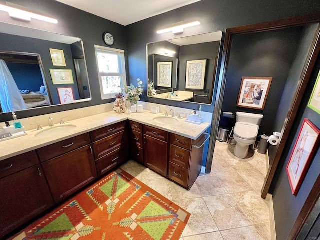 bathroom with toilet, tile patterned flooring, and vanity