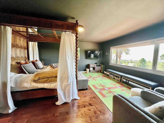 bedroom with lofted ceiling and hardwood / wood-style floors