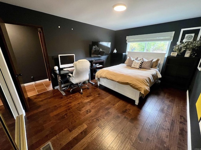 bedroom with visible vents and wood-type flooring