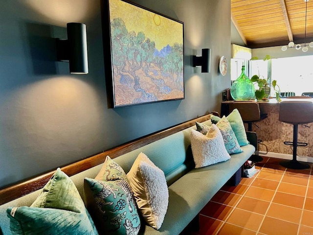 living area featuring wooden ceiling, tile patterned flooring, baseboards, and vaulted ceiling with beams