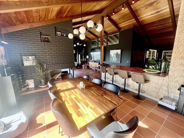 dining space featuring brick wall, wood ceiling, lofted ceiling with beams, and tile patterned floors