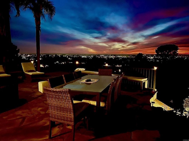 patio terrace at dusk featuring outdoor dining space